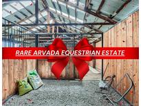 Arvada equestrian estate featuring stalls in a horse barn on the property at 13805 W 82Nd Ave, Arvada, CO 80005