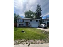 Charming two-story home featuring a well-manicured lawn and an attached garage, perfect for comfortable suburban living at 1477 S Wright Ct, Lakewood, CO 80228