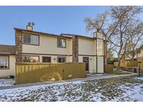 Attractive exterior of a townhome with a well-maintained yard and wooden fence at 1945 W 102Nd Ave, Thornton, CO 80260