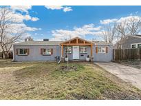 Charming single-story home features a cozy front porch, gray exterior paint, and decorative wooden shutters at 1970 Willow St, Denver, CO 80220