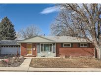 Brick ranch home with attached garage and landscaped yard at 7005 S Ash Cir, Centennial, CO 80122