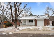 Charming brick home with a cozy front porch and attached one car garage at 31 W Fremont Ave, Littleton, CO 80120