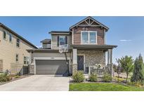 Two-story home with stone accents and a landscaped yard at 15983 E Warner Dr, Denver, CO 80239