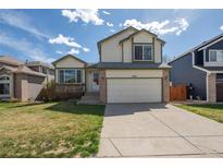 Charming two-story home with a well-maintained lawn and attached two-car garage at 9960 Kline St, Broomfield, CO 80021