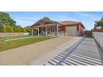 Charming single-story home with covered porch, long driveway, and attached one car garage at 11192 E 7Th Ave, Aurora, CO 80010