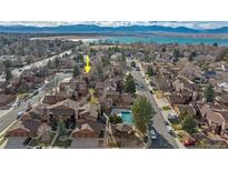 An aerial view of a residential community showcasing well-maintained buildings and a lake view in the background at 9411 W 89Th Cir, Westminster, CO 80021