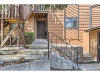A cozy home entrance with concrete steps and metal handrail lead to front door at 9411 W 89Th Cir, Westminster, CO 80021