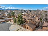 A captivating view of townhomes featuring an appealing exterior design and well-kept grounds set against a mountainous backdrop at 9411 W 89Th Cir, Westminster, CO 80021
