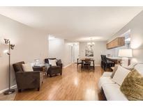 Inviting living room featuring hardwood floors, comfortable seating, and a cozy dining area at 9411 W 89Th Cir, Westminster, CO 80021