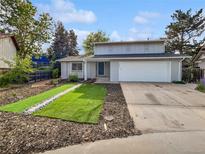 Charming two-story home featuring a well-manicured front yard and attached two-car garage at 3661 S Joplin St, Aurora, CO 80013