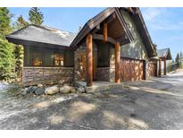 Inviting exterior with stone accents, wood beams, and a three-car garage adds to the curb appeal at 50 Cooney Ct, Breckenridge, CO 80424