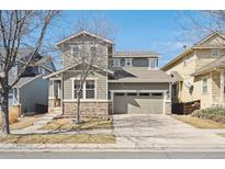 Charming two-story home featuring stone accents, a two-car garage and professional landscaping at 10251 Rifle St, Commerce City, CO 80022