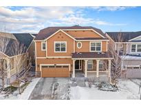 Charming two-story home featuring a two car garage, welcoming front porch and traditional architectural details at 22870 E Chenango Ave, Aurora, CO 80015