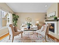 Cozy living room features a fireplace and hardwood floors at 25 Canongate Ln, Highlands Ranch, CO 80130