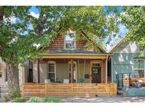 Charming craftsman home with a welcoming porch and modern fenced yard at 3607 Mariposa St, Denver, CO 80211