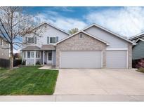 Charming two-story home featuring a three-car garage, well-maintained lawn, and inviting curb appeal at 11181 W Crestline Dr, Littleton, CO 80127