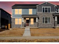 Charming two-story home with a combination of stone and siding exterior, a covered porch, and new landscaping at 791 N Tempe St, Aurora, CO 80018