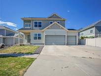 Charming two-story home featuring a spacious driveway and three car garage at 19155 Robins Dr, Denver, CO 80249