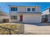 Charming two-story home with a red front door and well-maintained lawn in a residential neighborhood at 4774 Waldenwood Dr, Highlands Ranch, CO 80130
