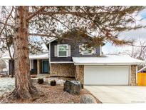 Charming two-story home with a stone facade and a two-car garage at 2014 S Pagosa St, Aurora, CO 80013