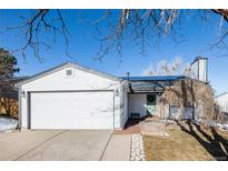 Charming ranch-style home with a two-car garage, solar panels, and inviting front entryway at 2719 S Truckee St, Aurora, CO 80013