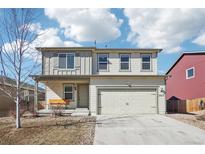 Charming two-story home featuring a two-car garage, covered porch with bench, and well-maintained landscaping at 2015 Wildwood St, Lochbuie, CO 80603
