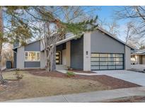 Modern home exterior boasts gray siding, glass garage door, and well-maintained landscaping with mature trees at 2201 Juniper Ct, Boulder, CO 80304