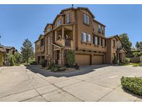 Stylish multi-story townhome featuring a stone facade, attached garages and well maintained landscaping at 10578 Parkington Ln # 35D, Highlands Ranch, CO 80126