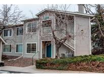 Inviting two-story home with a blue front door and a well-kept exterior at 8416 Pebble Creek Way # 203, Highlands Ranch, CO 80126