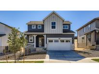 Charming two-story home featuring a two-car garage, inviting porch, and modern architectural details at 10968 Snowdon St, Parker, CO 80134