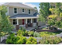 Two-story house with a red front door and landscaped yard at 2975 Thunder Lake Cir, Lafayette, CO 80026