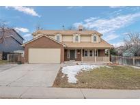 Brick two-story house with attached garage and landscaped yard at 4795 S Yank Way, Morrison, CO 80465