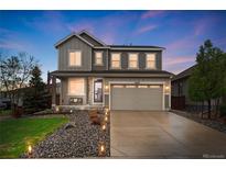 Charming two-story home with a well-manicured lawn, a covered porch, and a two-car garage at 16400 Alberta Dr, Parker, CO 80134