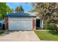 Charming single-story home featuring a brick and siding facade, attached garage, and well-maintained landscaping at 354 Willowick Cir, Highlands Ranch, CO 80129