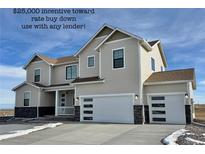 Inviting two-story home featuring a two-car garage, stone accents, and a covered front porch at 42968 Colonial Trl, Elizabeth, CO 80107