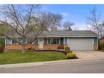 Charming single-story home with a well-manicured front yard and a two car garage at 7282 S Vance St, Littleton, CO 80128
