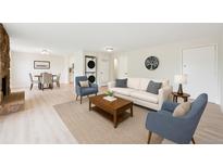 Bright living room featuring a decorative fireplace, modern furniture, and an adjacent dining area at 3365 Chisholm Trl # B102, Boulder, CO 80301