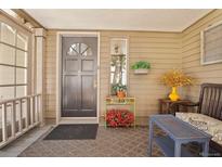 Inviting front porch features a stylish seating area and charming decor at 916 Griffith St, Georgetown, CO 80444