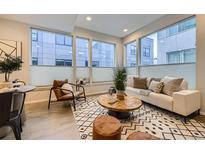 Bright living room features large windows, modern furniture, and stylish decor at 3256 Federal Blvd, Denver, CO 80211