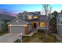 Charming two-story home with gray siding, brick accents, and a well-manicured front yard at 3898 Mallard St, Highlands Ranch, CO 80126
