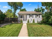 Charming single-story home with a well-manicured lawn and inviting walkway at 1645 Uinta St, Denver, CO 80220