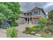 Charming two-story home featuring stone accents, a well-maintained yard, and a welcoming porch at 1839 Caleta Trl, Longmont, CO 80504