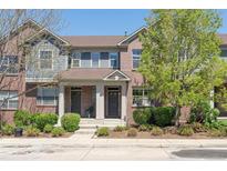 Charming brick townhome featuring a welcoming front porch and well-maintained landscaping at 7440 E 8Th Ave # 25, Denver, CO 80230