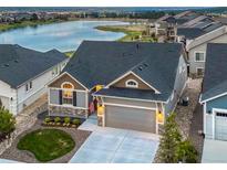 Charming single-Gathering home showcasing a well-manicured lawn with lake views at 2573 Lakes Edge Dr, Monument, CO 80132