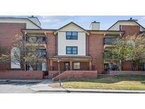 Inviting exterior view of the multi-story condo with brick accents and an outdoor porch at 13950 E Oxford Pl # B105, Aurora, CO 80014
