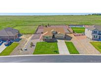 A beautiful home featuring a large lawn, spacious driveway, and a fenced backyard at 42073 Colonial Trl, Elizabeth, CO 80107