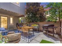 Outdoor patio space with a table and chairs and BBQ perfect for entertaining at 1152 S Yosemite Way # 29, Denver, CO 80247