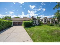 Charming home with a well-maintained front yard, driveway, and a two-car garage at 675 Holland St, Lakewood, CO 80215