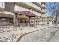 Holland House condo building with brick facade, covered entry, and landscaping features at 1313 Steele St # 606, Denver, CO 80206