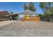 Charming single-story home featuring a welcoming front deck and a convenient covered carport at 695 S Quitman St, Denver, CO 80219